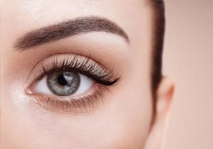 A detailed view of a woman's eyes with voluminous lashes, highlighting the effects of Latisse lash serum for enhanced beauty