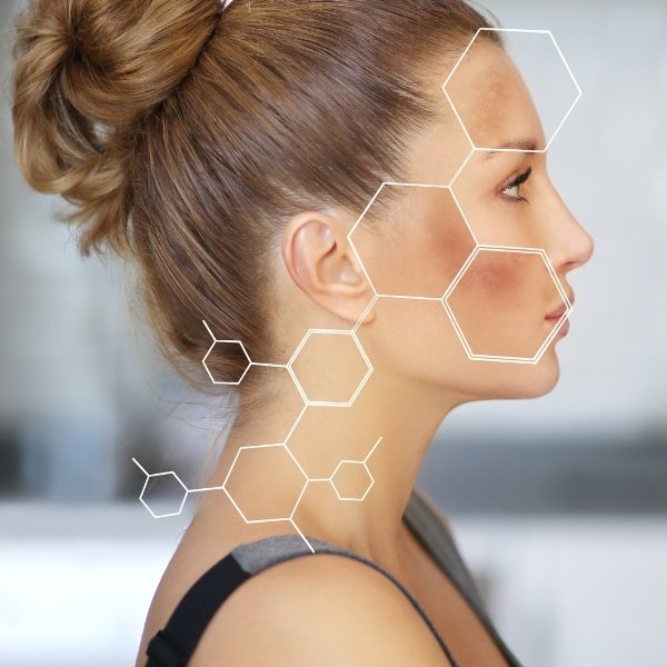 Profile view of a woman with light brown hair in a bun, overlaid with white hexagon shapes on her cheek and jaw, suggesting skincare benefits or facial analysis, possibly related to Obagi Hydroquinone. Background is softly blurred.