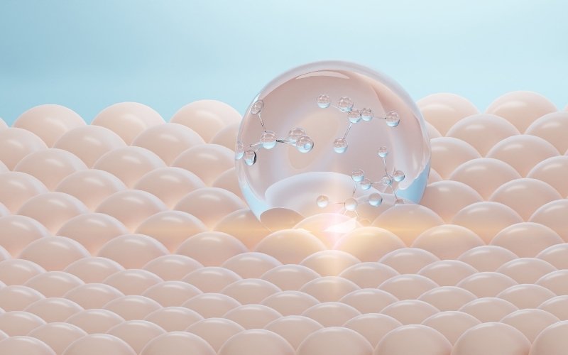 A clear sphere with molecules rests on smooth domes, evoking Obagi Tretinoin’s anti-aging touch.