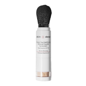 A tube of Skin Deep mineral powder sunscreen with an attached brush applicator.